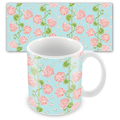 Pastel pink geranium repeated pattern on a pastel blue background on a mug